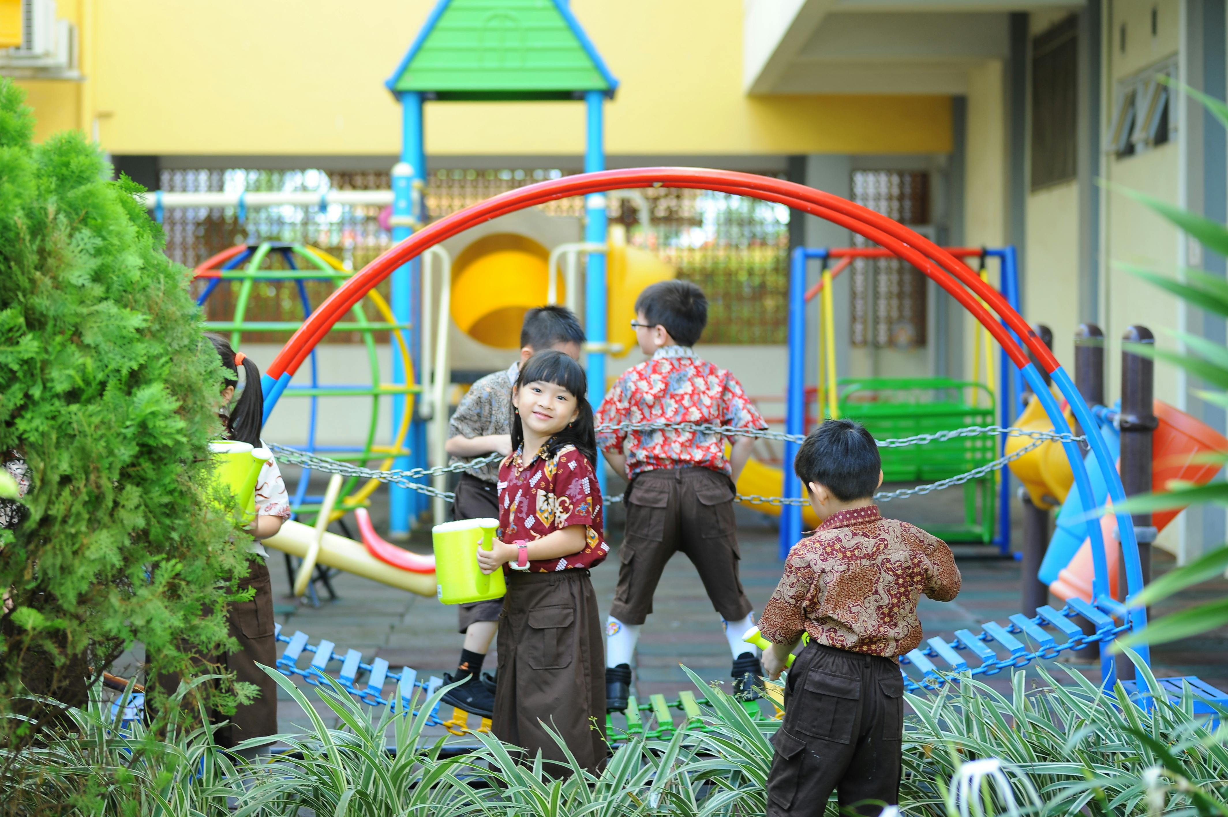 Children playing in a sunny schoolyard during recess.