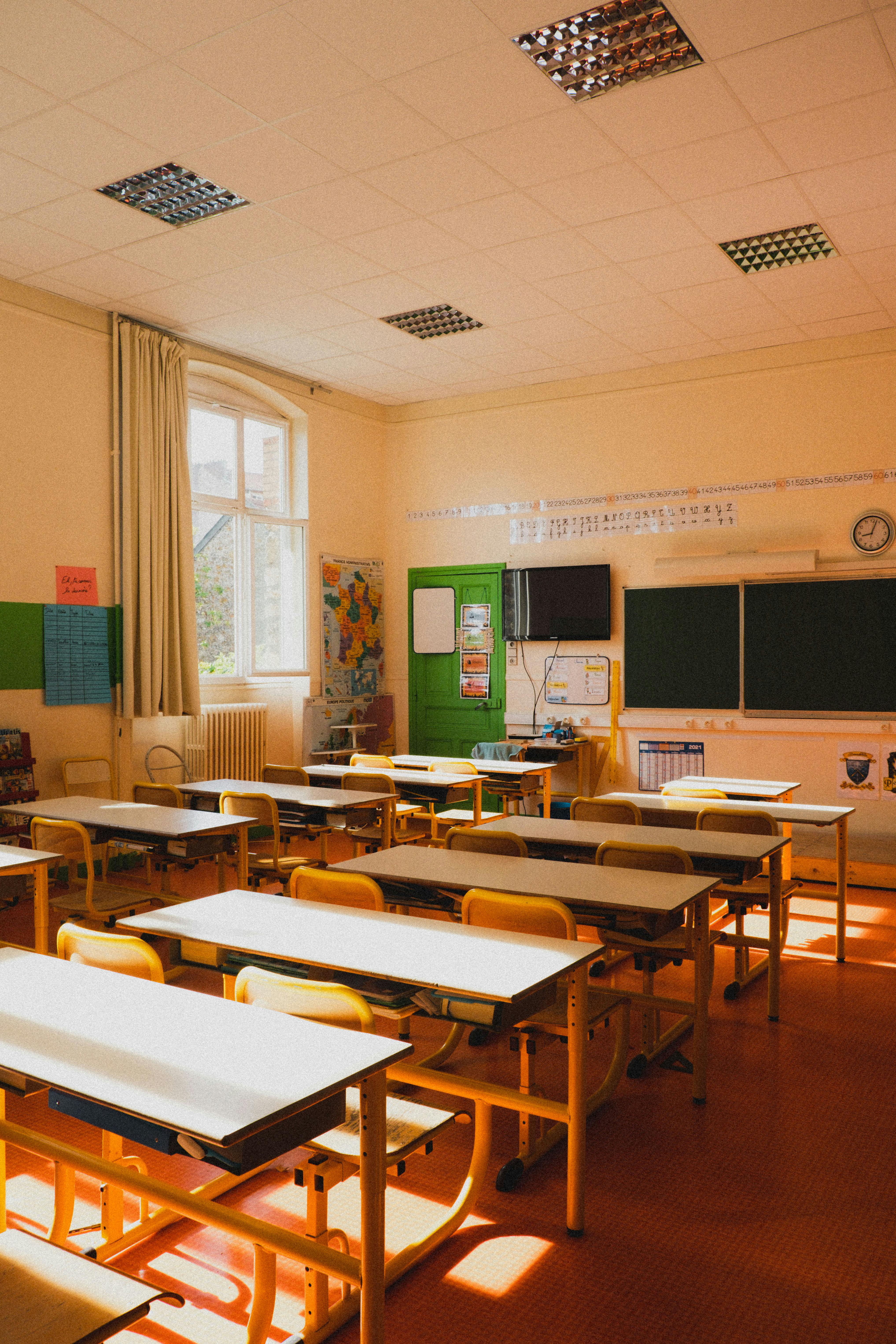 A nostalgic classroom scene with desks and warm afternoon light.